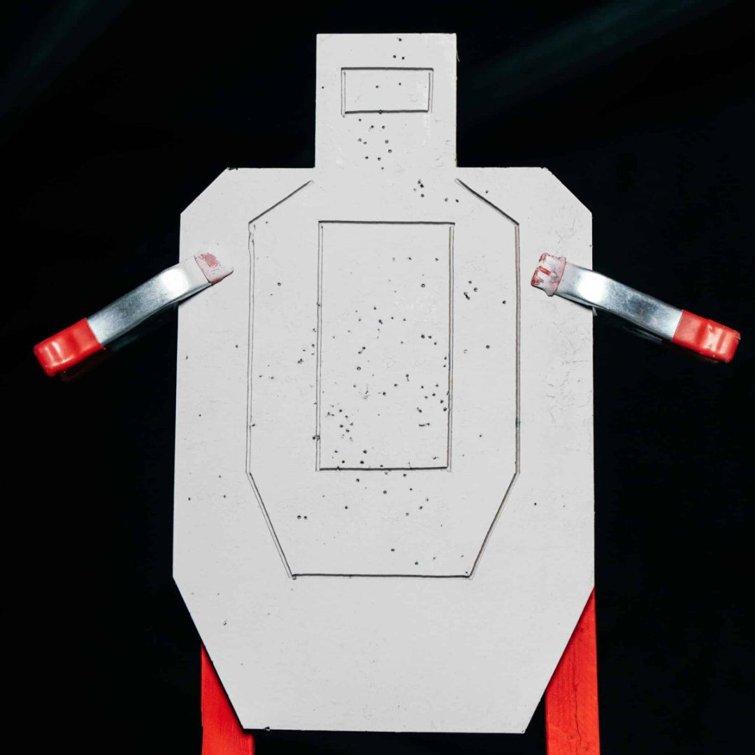 Rubber target with red and silver clamps on a black background
