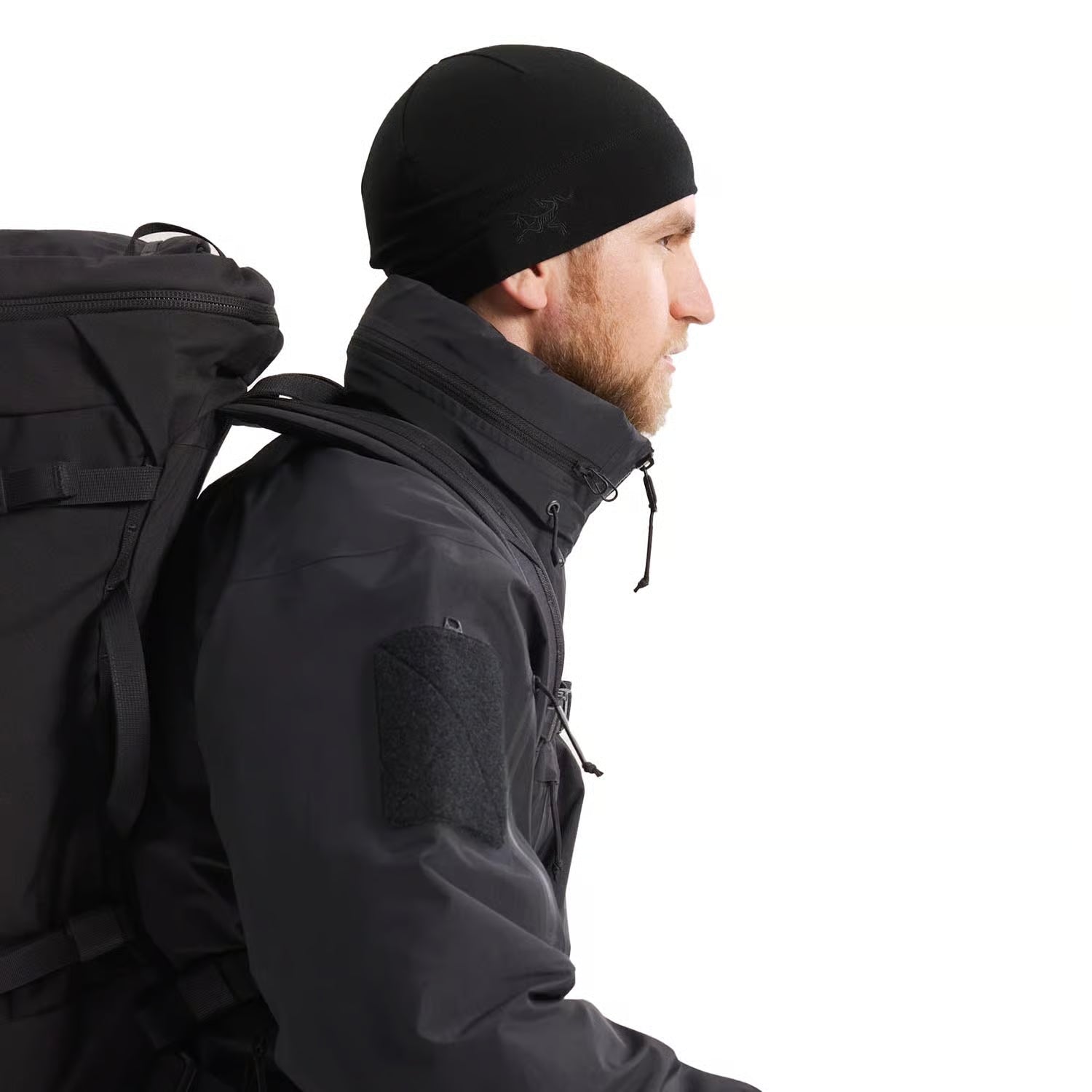 Arc'teryx PRO Alpha Jacket GEN 2.3 waterproof tactical shell worn with assault bag during field operations