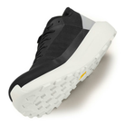 Black sneaker with white sole on a light gray background