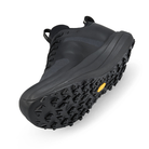 Black hiking shoe with a textured sole on a white background