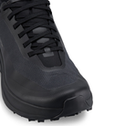 Black hiking shoe with textured sole on a light gray background
