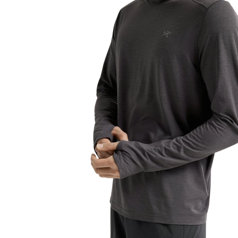 Close-up of the Arc'teryx Cormac Hoody in dark grey showing the integrated thumb loops, extended sleeve coverage, and lightweight textured fabric.