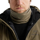 Image of the Arc'teryx Cold WX Neck Gaiter AR Wool in Crocodile being worn and layered in a cold-weather environment, showing the lightweight merino wool construction, low-profile fit, and heat-retaining design. Highlights moisture-wicking performance, stretch mobility, and winter-ready protection ideal for tactical cold weather operations and backcountry conditions.