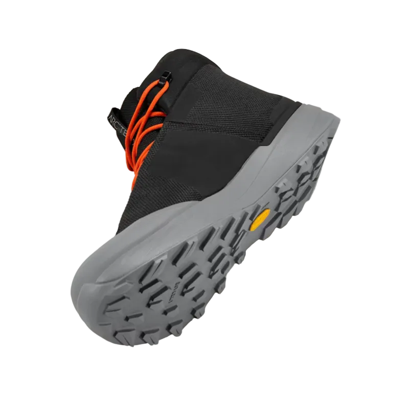 Three quarter underside view of Arc'teryx Kopec Mid GTX Boot Black Void showing Vibram Megagrip outsole pattern and medial side profile, lightweight waterproof tactical hiking boot built for traction and torsional stability on technical terrain
