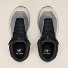 Pair of mid boots with a visible Arc'teryx brand logo on a light background