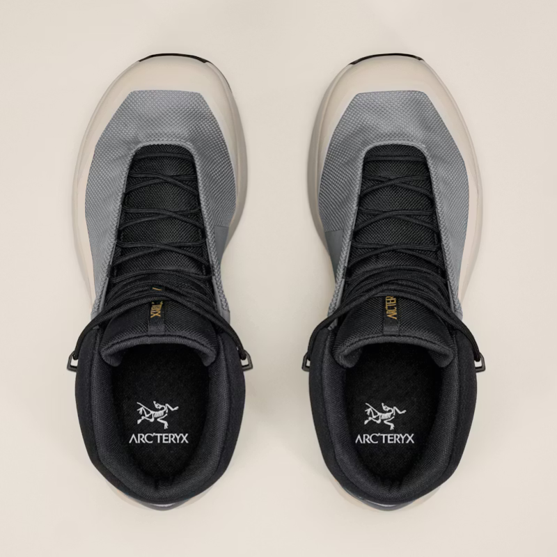 Pair of mid boots with a visible Arc'teryx brand logo on a light background