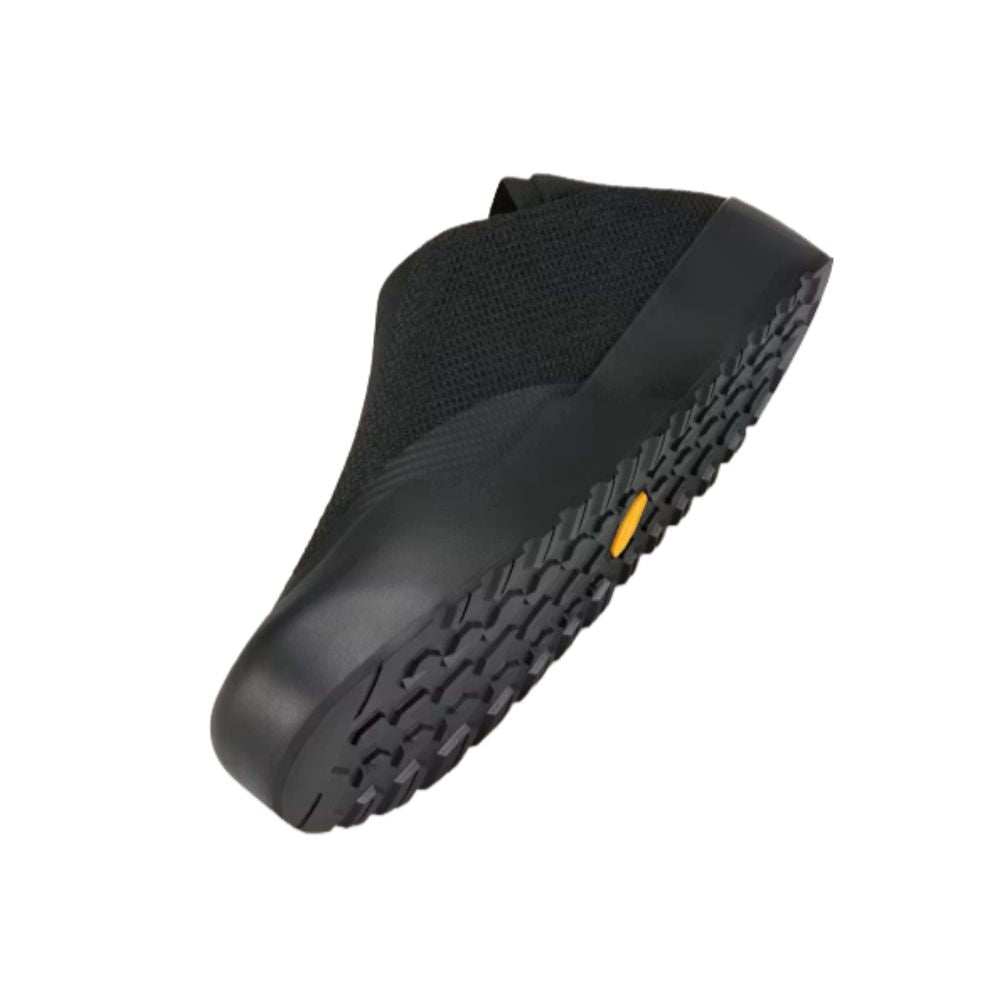 Angled bottom view of the Arc'teryx Kragg Shoe in Black showcasing the Vibram Megagrip outsole, durable rubber construction, and trail-ready lug pattern.