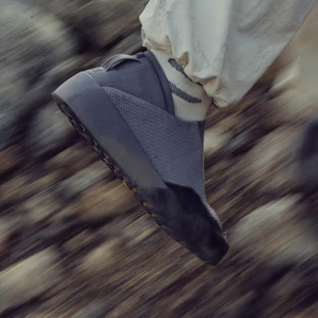 Person wearing the Arc'teryx Kragg Shoe while hiking on rugged terrain, demonstrating the lightweight construction, breathable upper, and approach-ready performance.