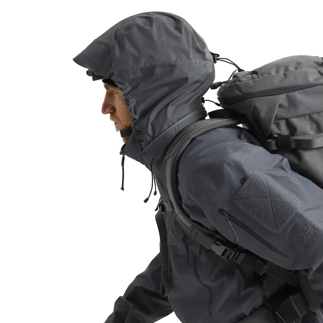 Close up view of the Arc'teryx LEAF Alpha Jacket Gen 2.2 in Wolf Grey with the hood in use, highlighting the StowHood design, weatherproof GORE TEX protection, and field ready construction for tactical operators and law enforcement across the United States.