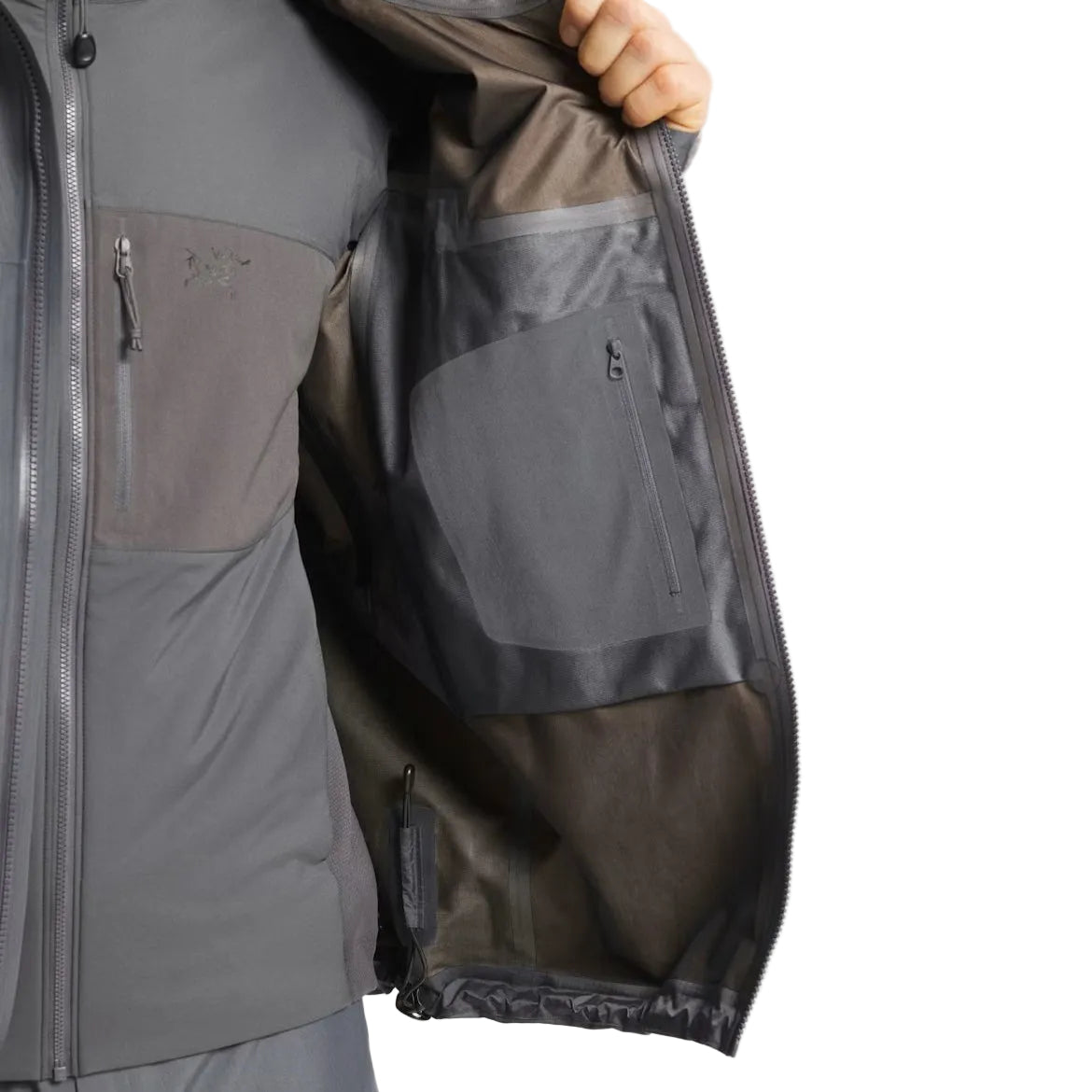 Close up view of the inside pocket and interior construction of the Arc'teryx LEAF Alpha Jacket Gen 2.2 in Wolf Grey showing the internal storage layout, seam finishing, and durable GORE TEX 3 layer design built for military and law enforcement operations across the United States.