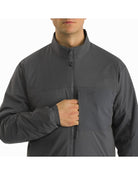 Close-up view of Arc'teryx LEAF Atom LT Gen 2.1 jacket showing zipper functions and secure tactical pocket design for mission-essential gear and midlayer performance.