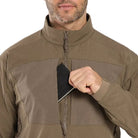 Image showing the Arc'teryx LEAF Practitioner AR Jacket in Crocodile with a hand accessing the front pocket, highlighting the dual chest pocket configuration, smooth No Slip Zip design, and functional storage layout engineered for tactical mobility and mission efficiency.