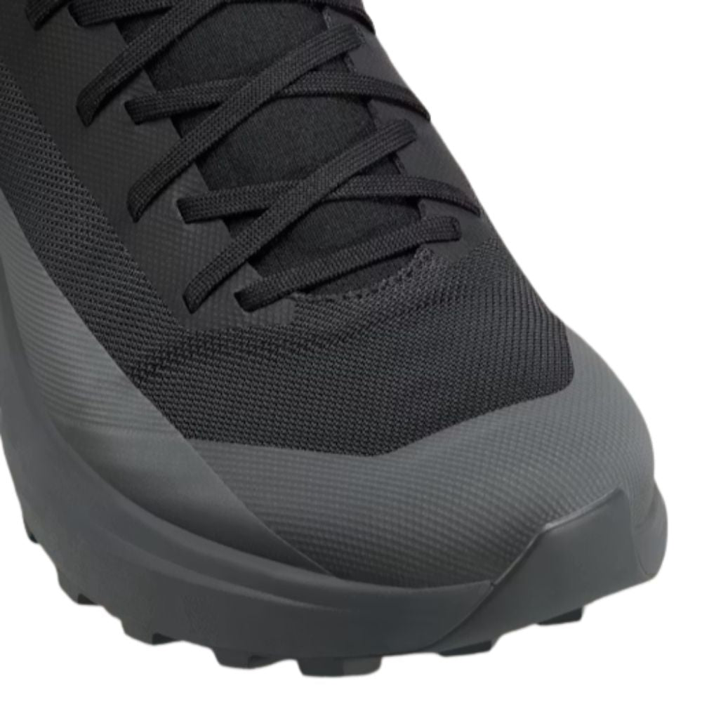 Close-up of the Arc'teryx Norvan LD 4 in Black/Graphite highlighting the reinforced toe cap, breathable woven upper, and precision lacing system.