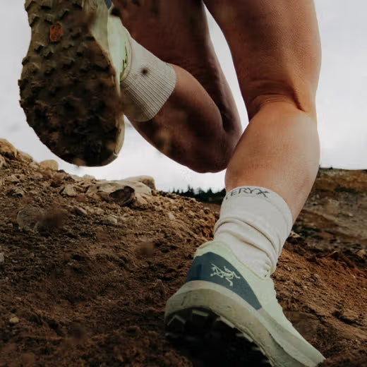 Arc'teryx Norvan LD 4 trail running shoe digging into loose dirt, demonstrating the Vibram Megagrip outsole and aggressive trail lug traction.