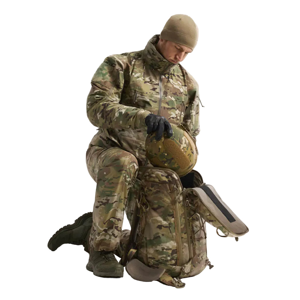 Arc'teryx PRO Alpha Jacket GEN 2.1 Multicam worn over tactical plate carrier demonstrating armor compatible military fit, waterproof GORE TEX combat shell engineered for layered cold and wet weather operations