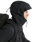 Close up of the Arc'teryx PRO Alpha LT Jacket Gen 2.2 in Black with the hood up, highlighting the fixed hood design, streamlined profile, and lightweight GORE TEX 3 layer construction. Part of the Arc'teryx PRO line, evolved from the LEAF program, and built for wet weather tactical operations.