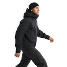 Full body side view of the Arc'teryx PRO Alpha LT Jacket Gen 2.2 in Black being worn, showing the streamlined tactical fit, arm logo placement, and lightweight GORE TEX 3 layer construction. The PRO Alpha LT, evolved from the Arc'teryx LEAF line, is designed for high mobility movement and wet weather field operations.