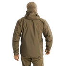 Back view of the Arc'teryx PRO Alpha LT Jacket Gen 2.2 in Crocodile being worn, showing the military fit patterning, streamlined hood design, and lightweight GORE TEX 3 layer construction. This PRO-series shell, evolved from the former Arc'teryx LEAF line, is built for wet weather tactical operations and high mobility field use.