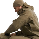 Close up view of the Arc'teryx PRO Alpha LT Jacket Gen 2.2 in Crocodile being worn with the side vent unzipped, showing the No Slip Zip ventilation system designed to release heat during high output movement. Highlights the lightweight GORE TEX 3 layer construction and PRO-series tactical design evolved from the former Arc'teryx LEAF line.