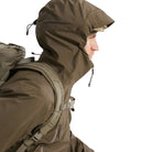 Side view of the Arc'teryx PRO Alpha LT Jacket Gen 2.2 in Ranger Green worn with the hood up, highlighting the hood adjustment points, streamlined fit, and lightweight GORE TEX 3 layer construction. The PRO Alpha LT, evolved from the Arc'teryx LEAF line, is designed for precise weather protection and high mobility in tactical environments.
