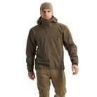Front worn view of the Arc'teryx PRO Alpha LT Jacket Gen 2.2 in Ranger Green showing the lightweight GORE TEX 3 layer construction, streamlined military fit, and low profile tactical design evolved from the Arc'teryx LEAF program. Demonstrates full weather protection and mobility for wet weather field operations.