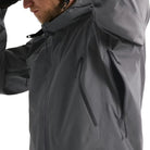 Detail view of the Arc'teryx PRO Alpha LT Jacket Gen 2.2 in Wolf Grey being worn with the side vent open, showing the No Slip Zip ventilation system, TPU zipper pulls, and seam construction. Highlights the PRO-series tactical design, evolved from the Arc'teryx LEAF program, engineered for heat management, mobility, and wet weather field performance.