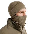 Three quarter view of the Arc'teryx PRO Assault Balaclava FR Gen 2 in Crocodile worn with the mouth and nose covered, highlighting the flame resistant Defender M mesh knit, enhanced breathability over the nose and mouth area, and ergonomic low-profile fit designed for helmet, comms, and eyewear integration. Built for direct action missions requiring FR protection and high airflow.