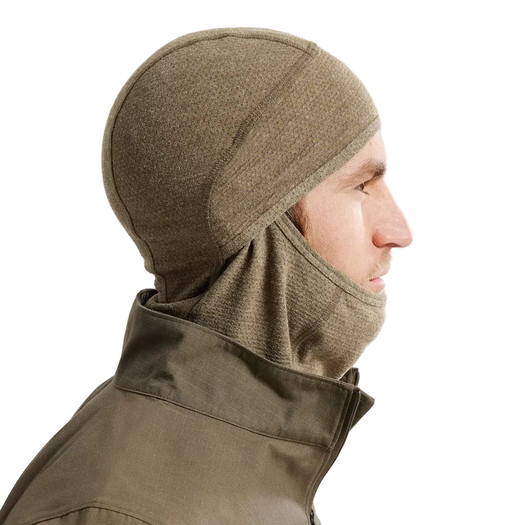 Side view of the Arc'teryx PRO Assault Balaclava FR Gen 2 in Crocodile worn with the fabric positioned under the chin, showing the flame resistant Defender M mesh knit, ergonomic shaping, and low-profile fit optimized for helmet compatibility and comms gear. Highlights breathable FR protection for direct action and high-mobility tactical environments.
