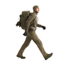 Full body shot of Arc'teryx PRO Atom LT Jacket Gen 2.1 in Crocodile being put on, modular tactical insulation layer designed for cold weather patrol, range work, and mission adaptable layering systems