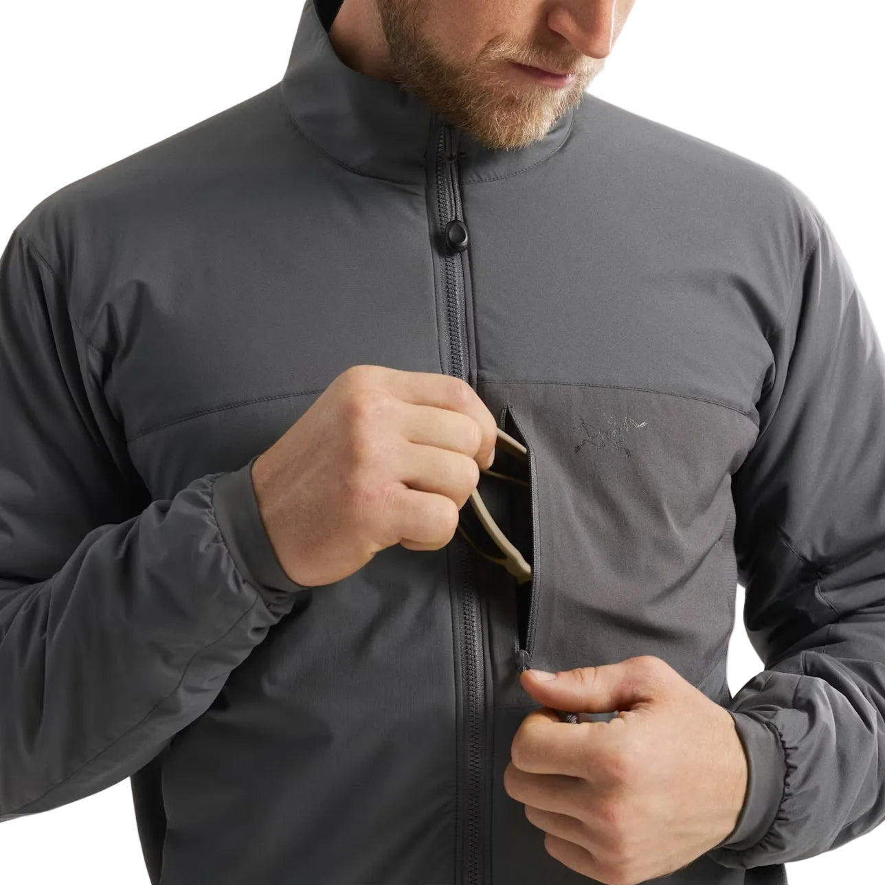 Wolf Grey Arc'teryx PRO Atom LT Gen 2.1 hand pocket accessed in field conditions, breathable insulated combat jacket with integrated media ports for communications routing