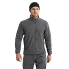 Arc'teryx PRO Atom LT Jacket Gen 2.1 in Wolf Grey worn from the front during cold weather movement, streamlined tactical insulation jacket compatible with armor systems and professional operational loadouts
