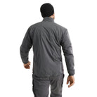 Rear view of Arc'teryx PRO Atom LT Gen 2.1 Wolf Grey worn in operational setting, breathable insulated reconnaissance jacket designed for mobility under plate carriers and load bearing equipment