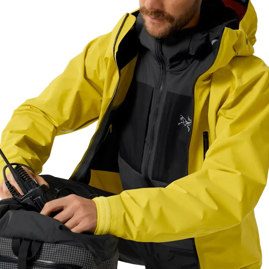 Image showing the Arc'teryx PRO Practitioner AR Hoody in Carbon Copy worn as a midlayer under outerwear, highlighting its breathable Fortius Air 50 fabric, Octa Loft insulation, and mission ready mobility for tactical operators and outdoor professionals in the United States.