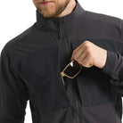 Close-up image of the Arc'teryx PRO Practitioner AR Jacket in Black showing the front chest pocket being used, highlighting the zippered storage, Fortius Air 50 shell, and low-profile tactical design. Demonstrates quick-access organization and mission-ready functionality of the PRO-series mid layer built for field operations and high-output movement.