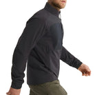 Side view of the Arc'teryx PRO Practitioner AR Jacket in Black being worn, showing the articulated patterning, streamlined Fortius Air 50 shell, and low-profile Octa Loft insulation. Highlights mobility, breathability, and mission-ready performance of this PRO-series tactical mid layer, evolved from the Arc'teryx LEAF line for high-output field movement.