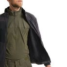 Arc'teryx PRO Practitioner AR Jacket in Black worn open as an outer layer, showing the breathable Fortius Air 50 shell, Octa Loft insulation, and articulated fit that layers cleanly over additional jackets or gear. Highlights its versatility as a lightweight tactical outer shell for high-output missions, temperature swings, and field-ready mobility.