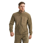 Front view of the Arc'teryx PRO Practitioner AR Jacket in Crocodile being worn, showing the Fortius Air 50 breathable shell, Octa Loft insulation, and articulated fit designed for mobility in tactical environments. Highlights the PRO-series mid layer’s ability to regulate heat, move under load, and deliver mission-ready performance in changing conditions.