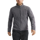 Front view of the Arc'teryx PRO Practitioner AR Jacket in Wolf Grey being worn, showing the streamlined tactical fit, dual chest pockets, and breathable Fortius Air 50 shell. Emphasizes the Octa Loft insulation, temperature-regulating performance, and professional-grade mobility designed for law enforcement, military operations, and technical layering in cold or dynamic environments.