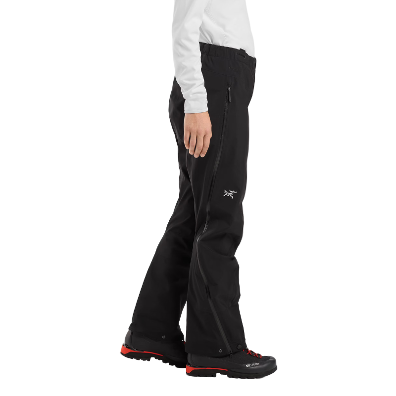 Side view of the Arc'teryx Women’s Alpine Guide Pant being worn showing the fitted GORE TEX PRO ski shell design for alpine guides and mountain rescue, featured in the Arc'teryx on sale winter collection.