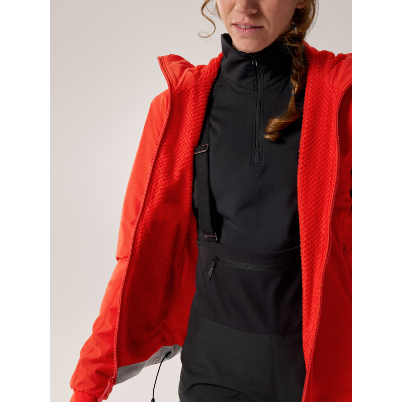Front view of the Arc'teryx Women’s Practitioner AR Hoody in the Dynasty red colorway worn open to show the Octa Loft insulation and breathable Fortius Air 50 design, featured as an Arc'teryx on sale alpine mid layer.