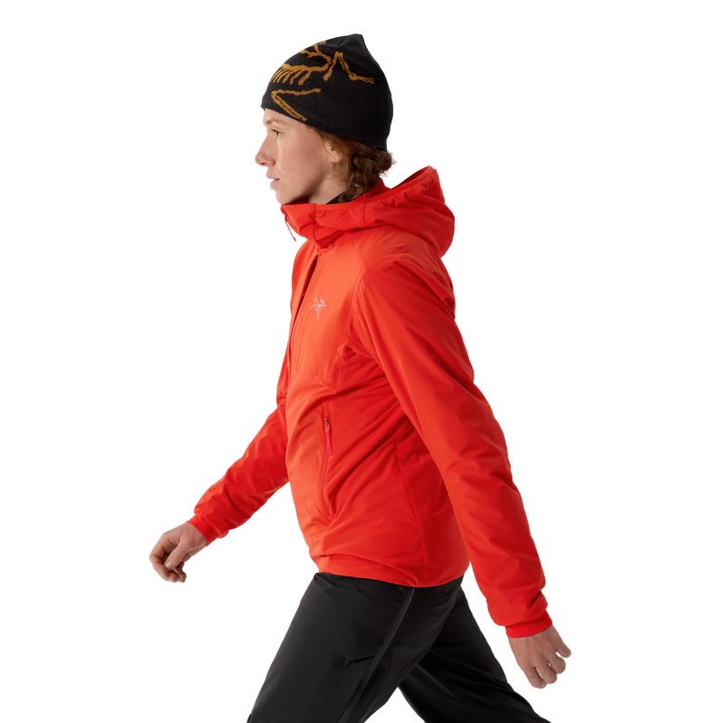 Side view of the Arc'teryx Women’s Practitioner AR Hoody in the Dynasty red colorway showing the lightweight Octa Loft insulated alpine mid layer being worn, featured as an Arc'teryx on sale item and built for high output mountain performance.