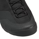 Close-up of a black athletic shoe showing the lace-up area, textured upper, and part of the sole against a white background.