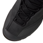 Close-up of a black hiking boot showing the toe, laces, and textured upper against a white background.