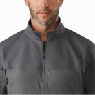 Close-up of the Arc’teryx PRO Assault Combat Shirt collar and upper front showing the low-profile zip neck design that protects the throat and allows ventilation. Built from no melt/no drip NYCO Cordura® ripstop and Cyberknit jersey, this combat shirt is PPE-compatible and engineered for body armor integration.