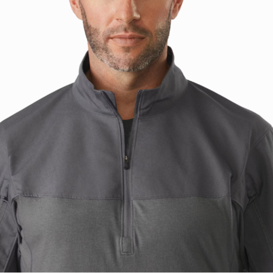 Close-up of the Arc’teryx PRO Assault Combat Shirt collar and upper front showing the low-profile zip neck design that protects the throat and allows ventilation. Built from no melt/no drip NYCO Cordura® ripstop and Cyberknit jersey, this combat shirt is PPE-compatible and engineered for body armor integration.