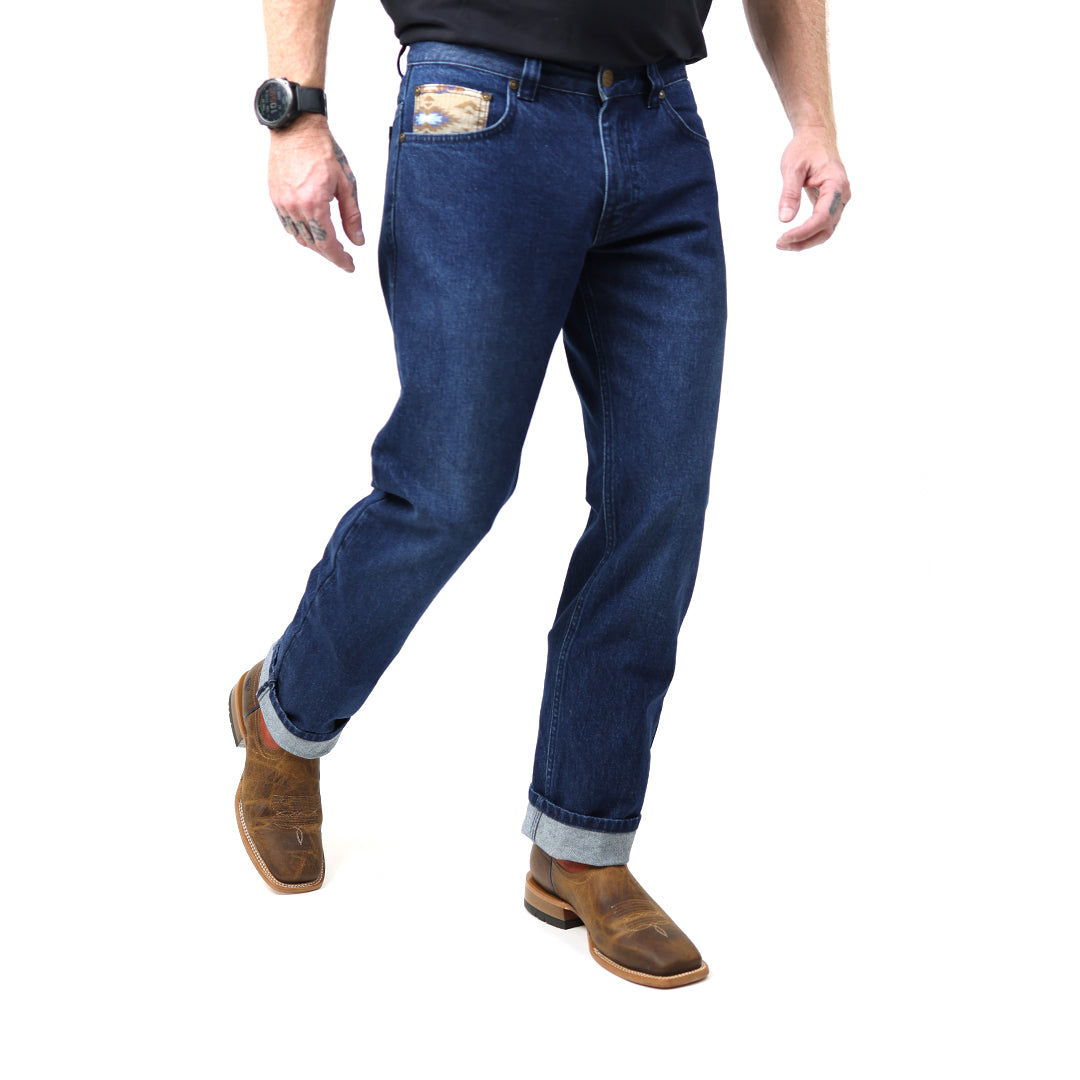 Person wearing blue jeans and brown boots on a white background