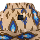 Close-up of a patterned garment showing a beige base with brown, blue, and light blue geometric Southwestern-style motifs, plus a small black brand patch centered on the chest.