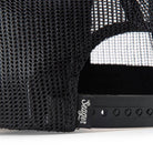 Close-up of a black mesh cap with a Seager brand logo on a white background