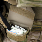 Blue Force Gear Boo Boo Kit Pouch opened to reveal organized medical supplies and small gear for rapid access in the field.