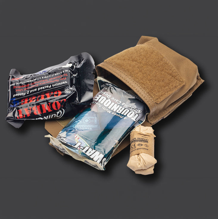 Blue Force Gear Boo Boo Kit Pouch carrying emergency supplies including batteries, water purification tablets, and survival essentials in a compact MOLLE pouch.